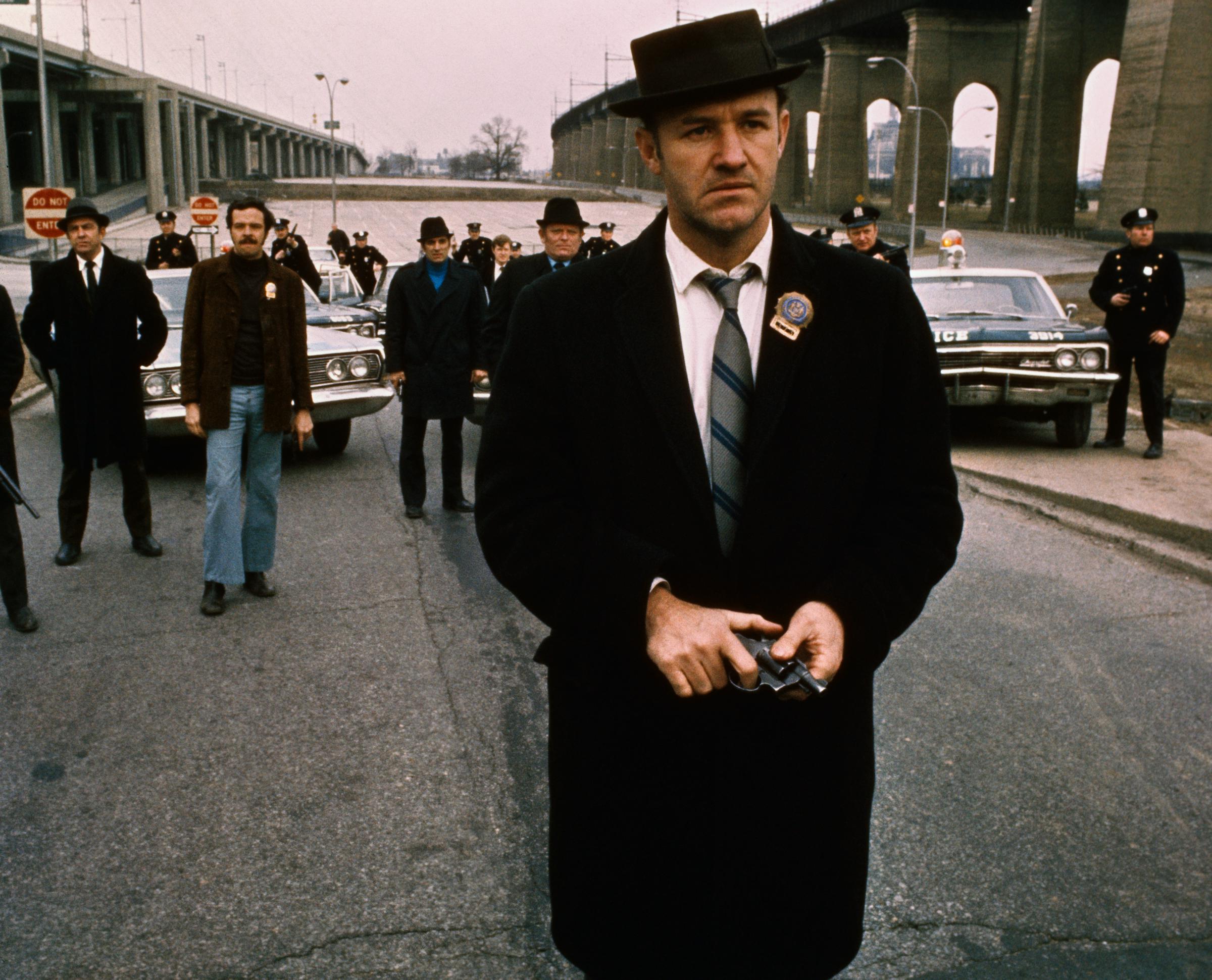 Gene Hackman in a still from "The French Connection," where he walks toward the camera with a gun—his Best Actor–winning role—from 1971. | Source: Getty Images