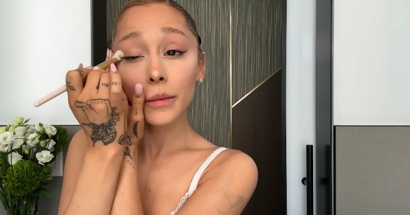 Ariana Grande doing her beauty routine from a post dated September 12, 2023. | Source: YouTube\Vogue