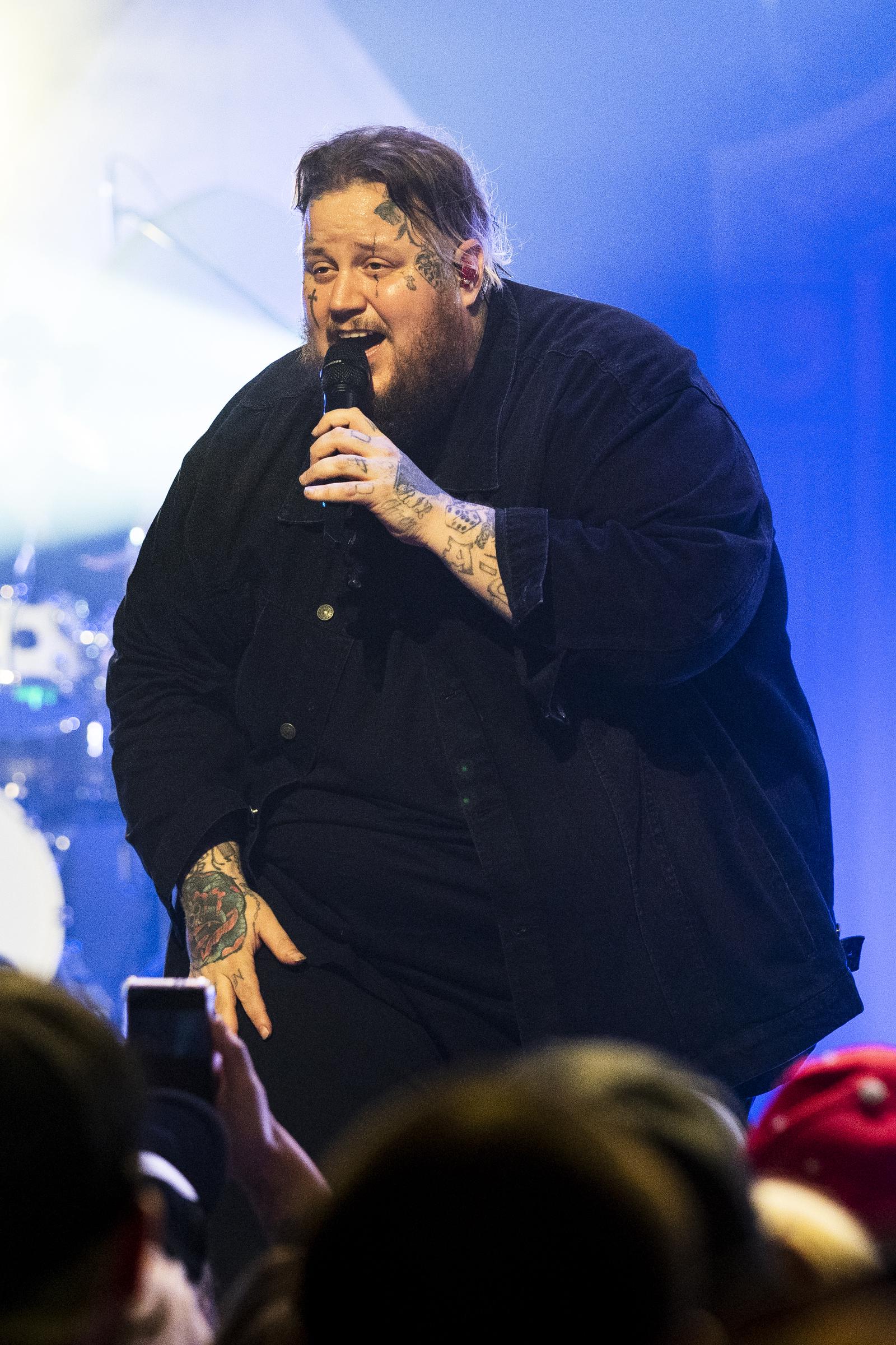 Jelly Roll performs in an oversized all-black outfit at the Orpheum Theater in New Orleans, Louisiana, on November 12, 2021.