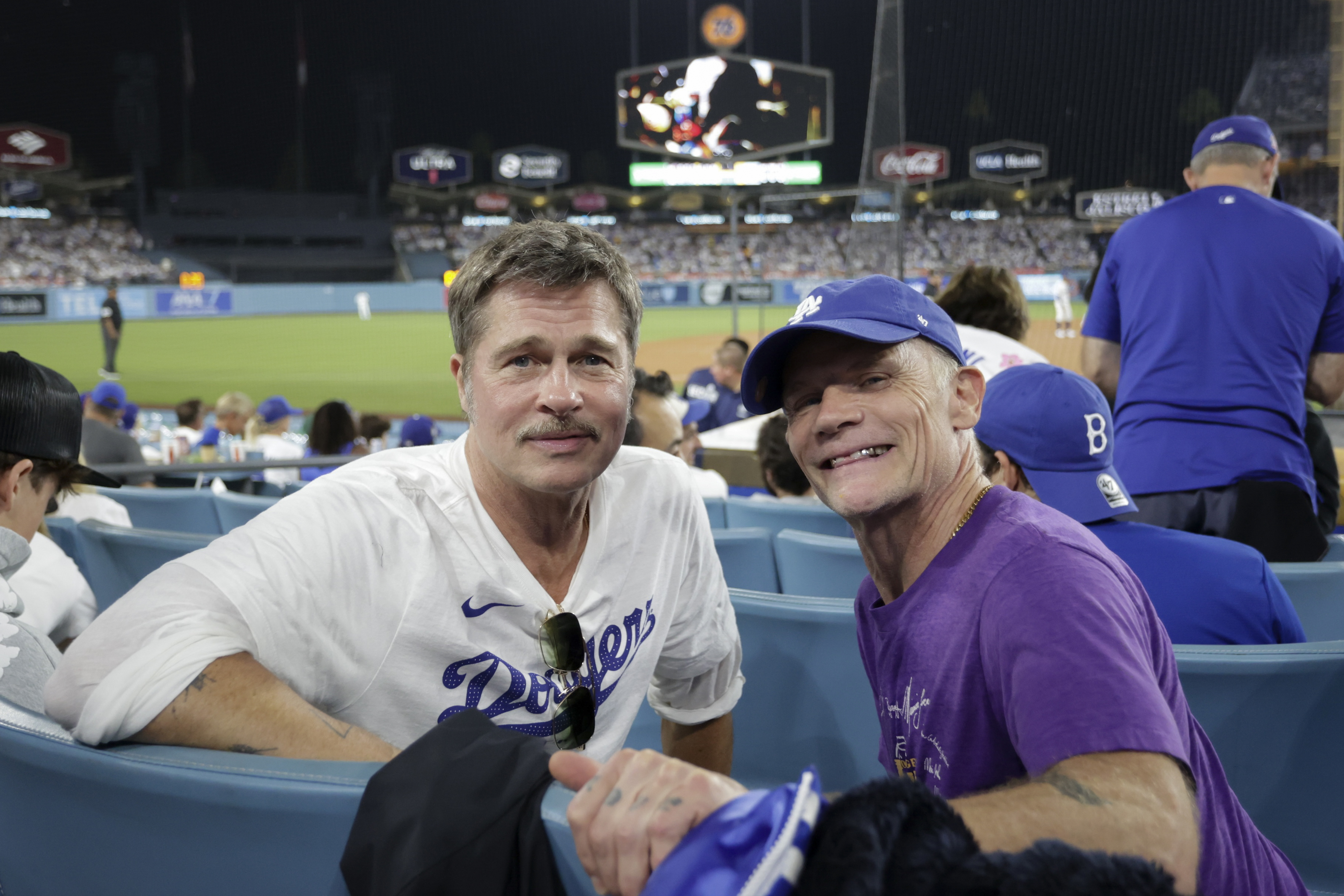 Brad Pitt and Flea (Michael Peter Balzary) posing for a photo during Game Four of the World Series between the Toronto Blue Jays and Los Angeles Dodgers in California on October 28, 2025. | Source: Getty Images