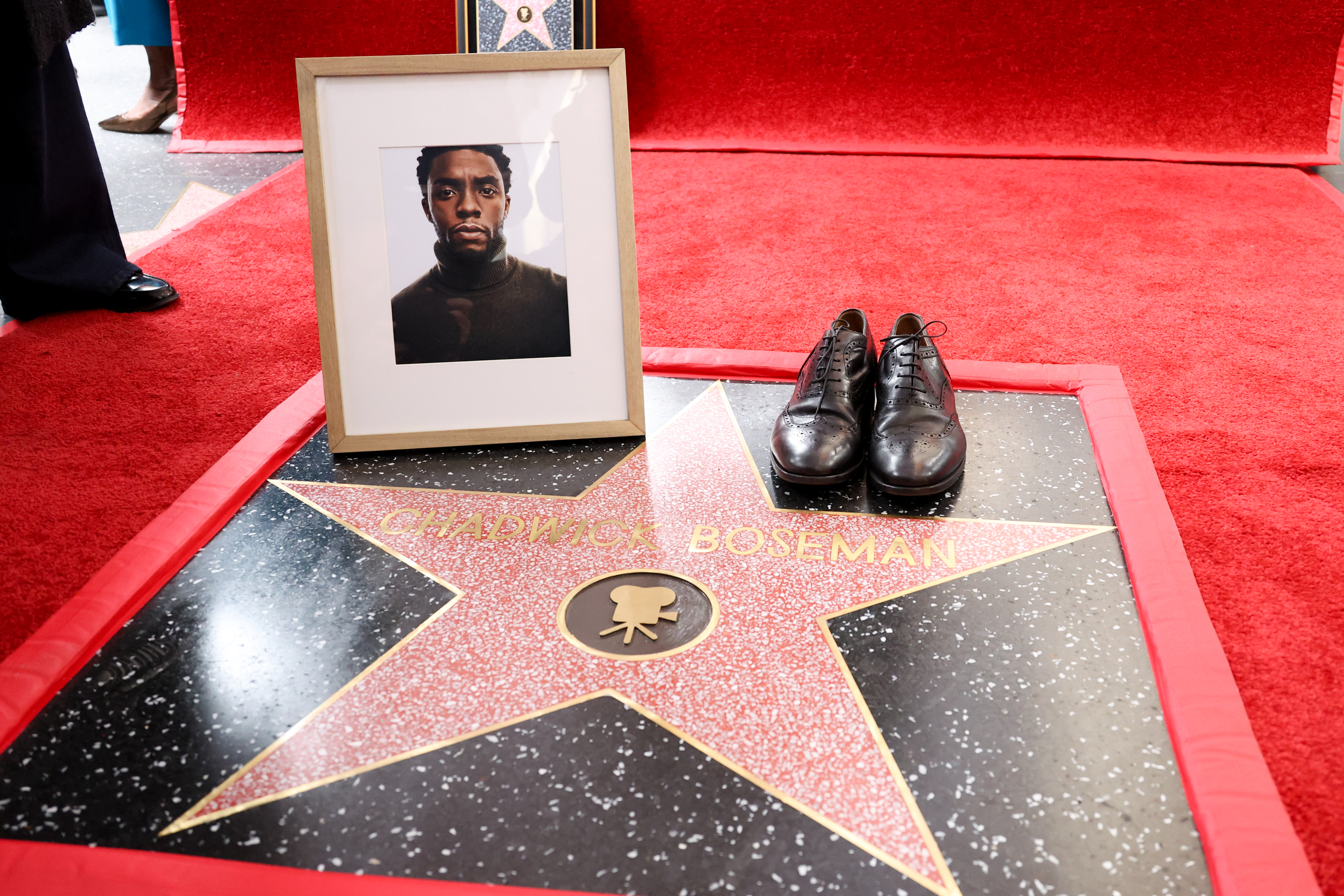 A picture of Chadwick Boseman and his shoes seen during the ceremony where he was  honored with a Posthumous Star on the Hollywood Walk of Fame on November 20, 2025 | Source: Getty Images