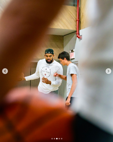 Karl-Anthony Towns having a one-on-one moment with John "Jack" Edward Thomas Moynahan as Tom Brady looks on outside the frame. | Source: Instagram/karltowns