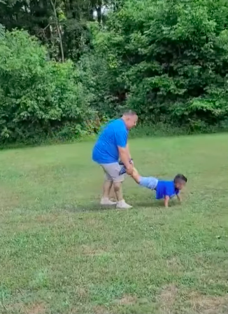 Juan Torres playing a wheelbarrow race game with his son Abel Torres-Aquino. | Source: YouTube/11Alive