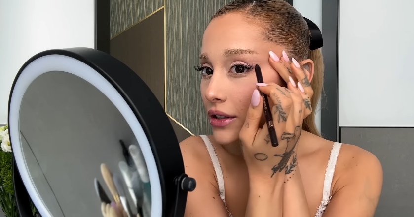 Ariana Grande doing her beauty routine from a post dated September 12, 2023. | Source: YouTube\Vogue