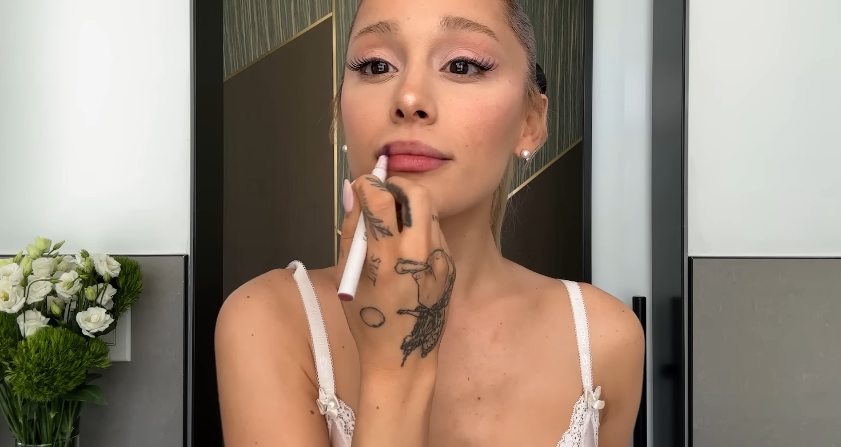Ariana Grande doing her beauty routine from a post dated September 12, 2023. | Source: YouTube\Vogue