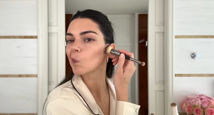 Kendall Jenner doing her Spring French girl makeup routine from a post dated April 11, 2024. | Source: YouTube\Vogue