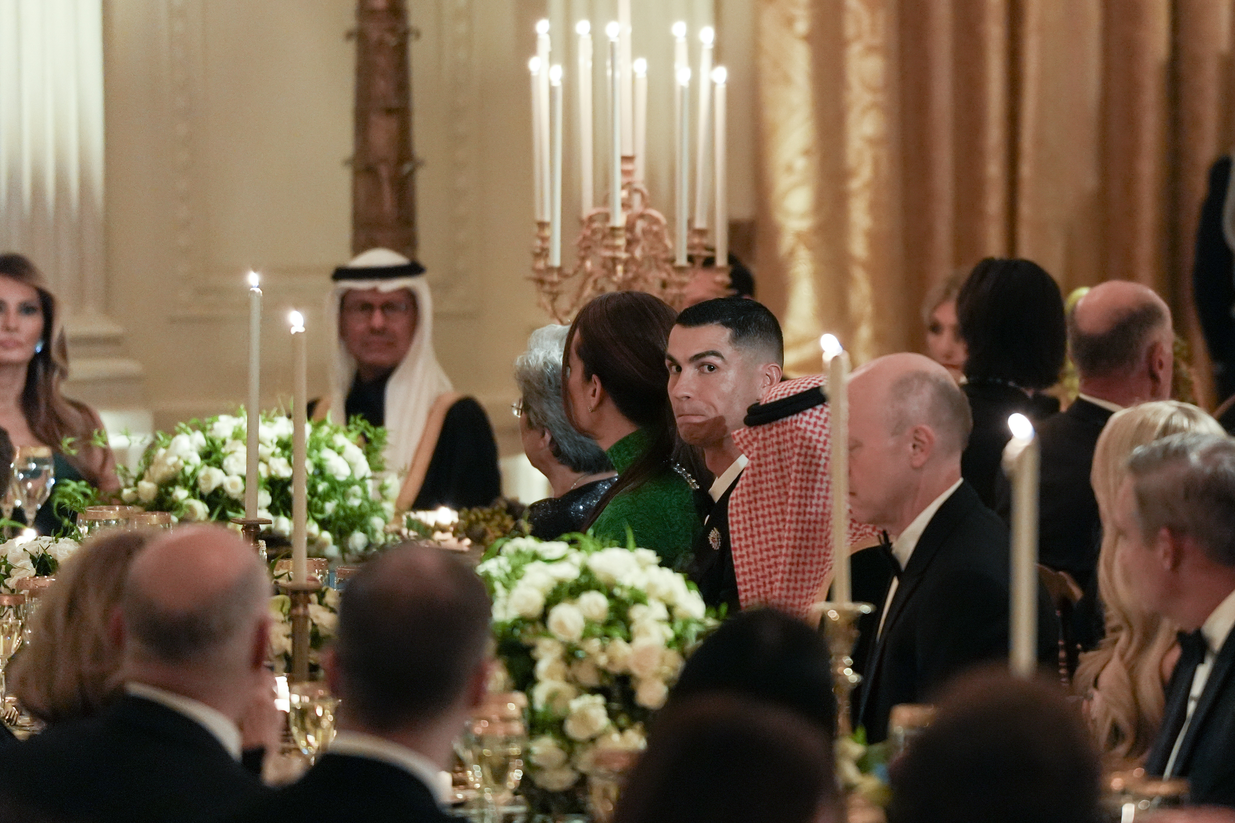 Cristiano Ronaldo listens as President Donald Trump speaks during a dinner in the East Room of the White House in Washington, DC, on November 18, 2025 | Source: Getty Images