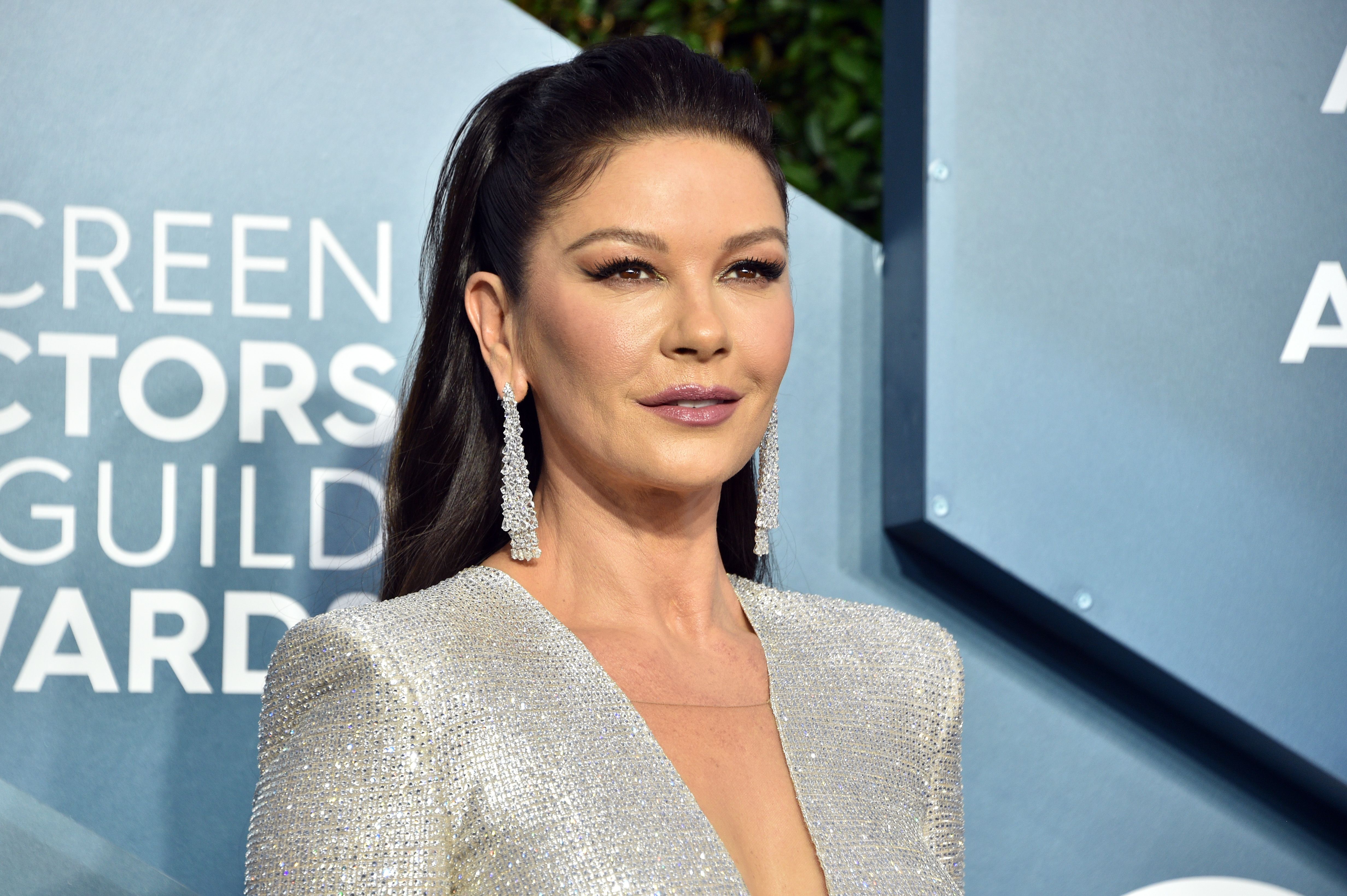 Zeta-Jones looking stunning in a silver deep V-cut gown paired with dangling earrings, highlighting her refined and polished look at the 26th Annual Screen Actors Guild Awards on January 19, 2020, in Los Angeles, California.