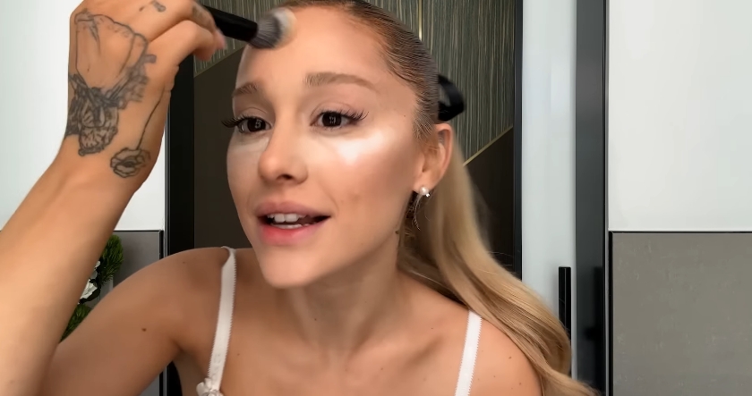 Ariana Grande doing her beauty routine from a post dated September 12, 2023. | Source: YouTube\Vogue