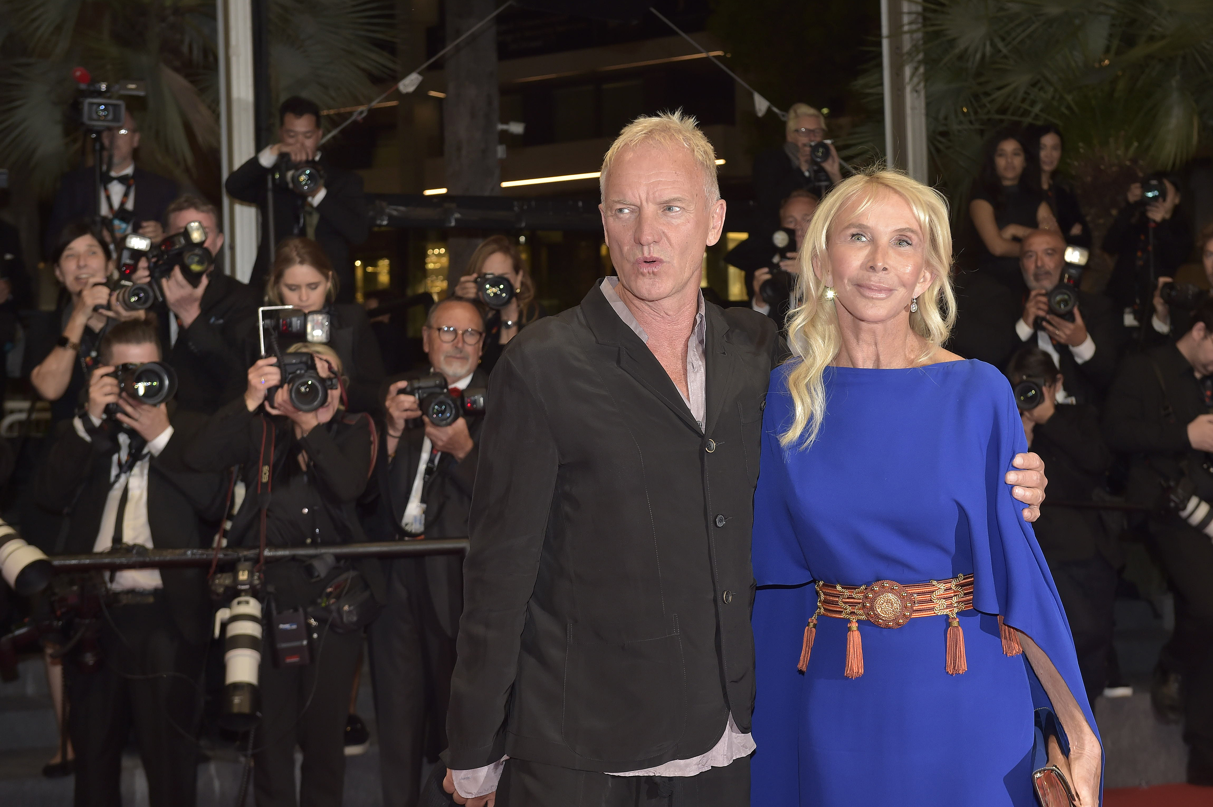 Trudie Styler wears a striking royal blue kaftan-style dress featuring wide sleeves and cinched at the waist, as she attends the "Parthenope" red carpet with Sting at the Cannes Film Festival on May 21, 2024, in Cannes, France.