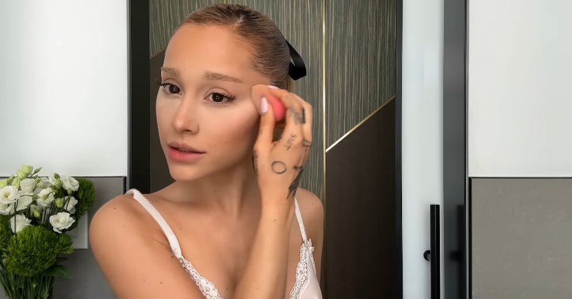 Ariana Grande doing her beauty routine from a post dated September 12, 2023. | Source: YouTube\Vogue
