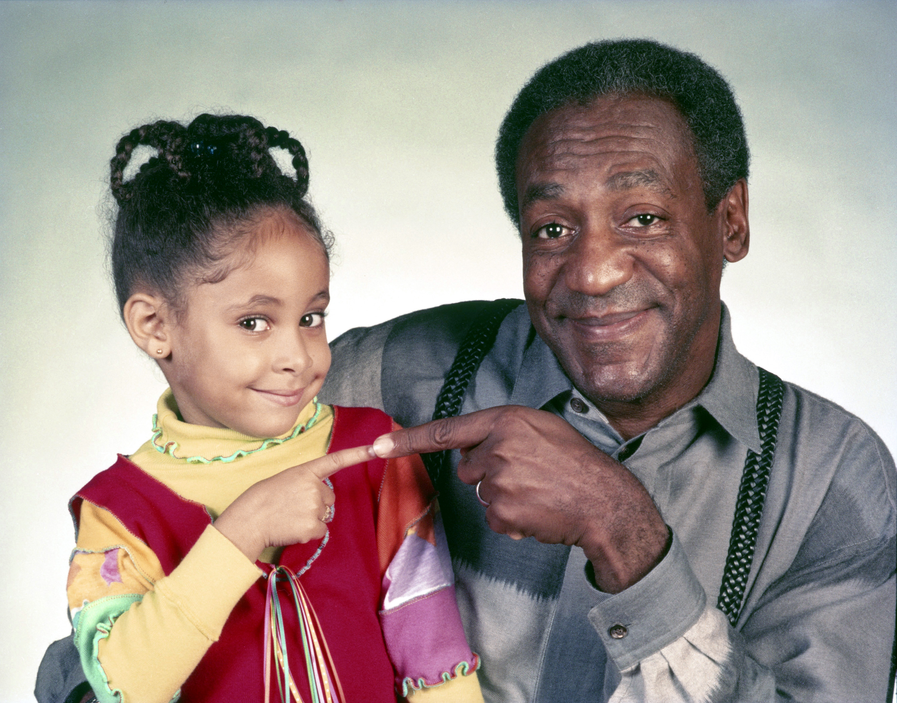 Raven Symone as Olivia Kendall, and Bill Cosby as Dr. Heathcliff Huxtable are seen on the set of "The Cosby Show," circa 1991. | Source: Getty Images